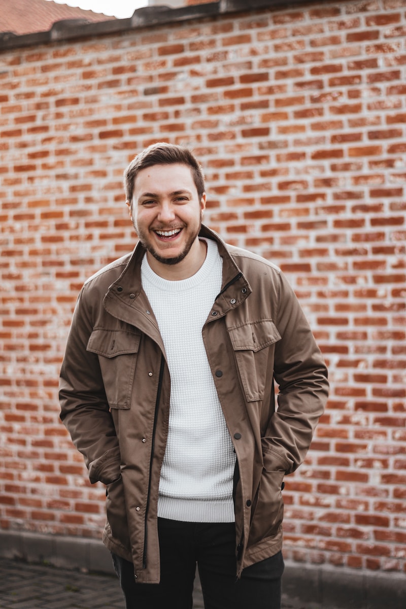 man in brown leather jacket smiling