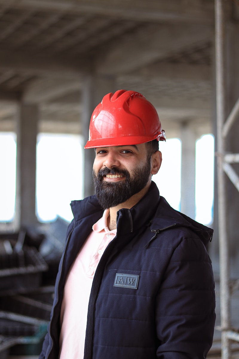 a man wearing a red hard hat and jacket